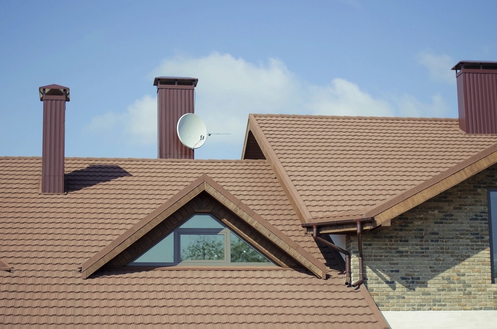 New tile roof with a matching gutter and downspout